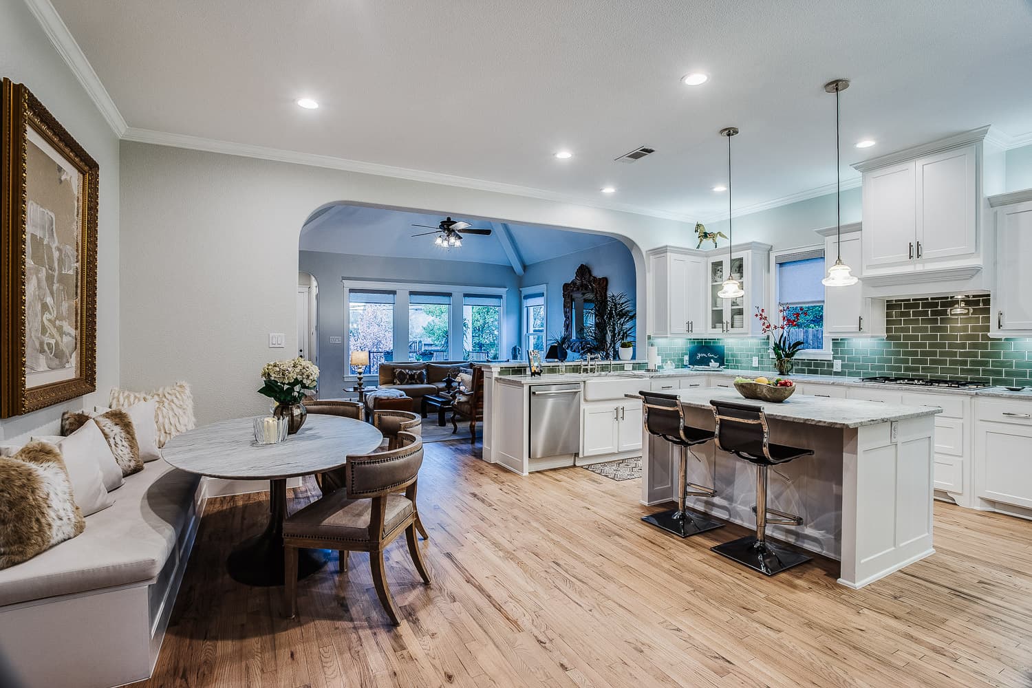 Open kitchen and dining area with light hardwood flooring — Rise Reno