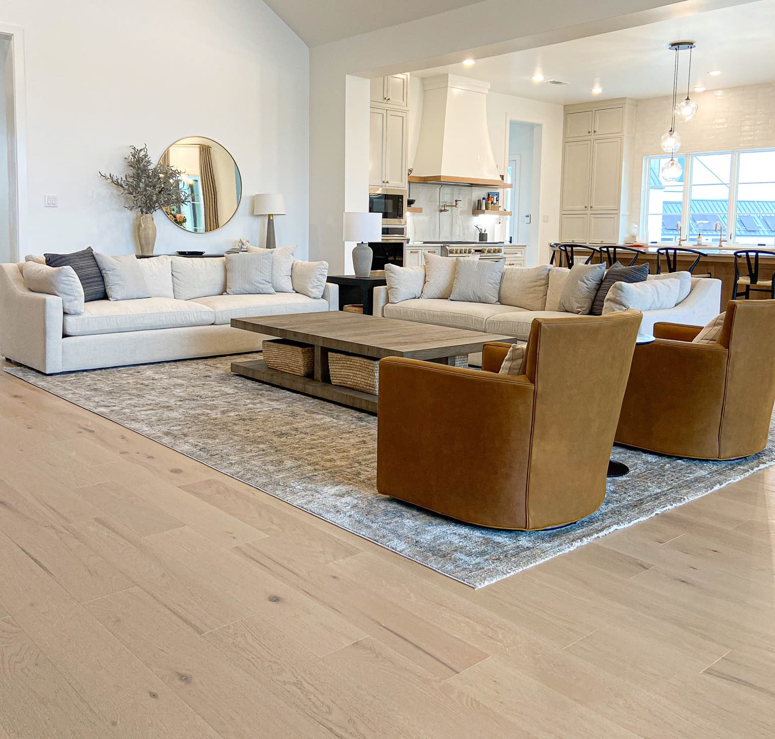 Open-concept living room with light wide-plank hardwood — Rise Reno